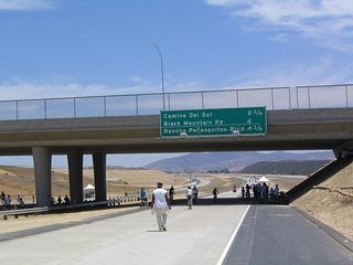 Bicyclists traveling on California 56 eastbound at the Carmel Valley Road interchange.