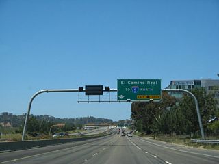 This new sign bridge was posted with the completion of the southbound Local Bypass for Interstate 5 in 2007. A ramp metering signal is activated when traffic warrants for the connection from California 56 west to Interstate 5 south.