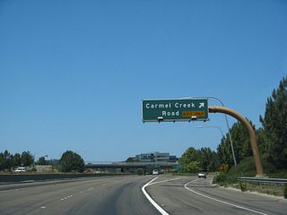 Westbound California 56 reaches Exit 1C, Carmel Creek Road. Unlike eastbound, there is no collector distributor lane used for the westbound ramps onto Carmel Creek Road.