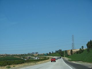 A San Diego Gas and Electric power line crosses California 56 (Ted Williams Freeway) near the boundary between Torrey Highlands and Pacific Highlands Ranch communities. To the south of the freeway is undeveloped Los Peñasquitos Canyon Preserve, which is part of an extensive open space park system owned by the City of San Diego.