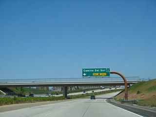 Once again, the westbound lanes widen out to three lanes. The right two lanes will connect to Exit 6, Camino del Sur to the Torrey Highlands community. Use Camino del Sur north to the communities of Black Mountain Ranch and Del Sur. The green overlay on this sign covers the name "Camino Ruiz," which is the original name of Camino del Sur. Once the Black Mountain Ranch community is built out, Camino del Sur will connect with Camino del Norte.