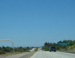 An exit number sign is posted for Exit 8, Rancho Peñasquitos Boulevard. This sign also mentions Carmel Mountain Road, which has paralleled California 56 since the Interstate 15 interchange.