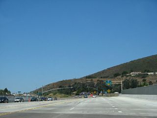 A six-lane concrete bridge, replaced in 2007 due to the Interstate 15 managed lanes project, carries three lanes in each direction. The next ramp connects to Interstate 15 south to Mira Mesa, Mission Valley, and downtown San Diego.