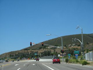 California 56 and state maintenance begin at the Interstate 15 interchange. The traffic signal between Ted Williams Parkway and Interstate 15 is the only traffic signal on California 56. Turn right here to Interstate 15 north; continue straight ahead for Interstate 15 south.