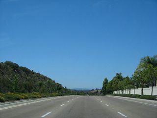 Ted Williams Parkway west after the traffic signal at Shoal Creek Road. Although this section is not officially state highway, it carries three westbound lanes and has a 55 mile per hour speed limit. Due to the traffic signals at the Interstate 15 interchange, this section of highway is an expressway, not a freeway.