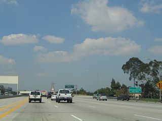 A roadside sign identifies Exit 1B with an exit number. Signs such as this were added along northbound California 57 in 2004.