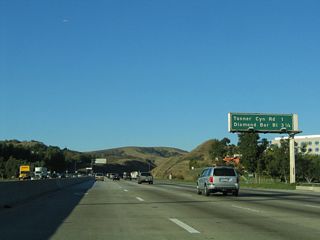 The next exit along northbound California 57 is Exit 11, Tonner Canyon Road, one mile. California 57 passes through the undeveloped Puente Hills and Brea Canyon, reemerging in civilization at Diamond Bar in Los Angeles County.