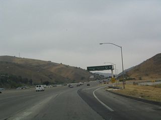Northbound California 57 (Orange Freeway) reaches Exit 11, Tonner Canyon Road.