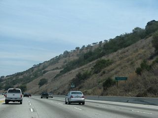 In the midst of Puente Hills/Brea Canyon, California 57 departs Orange County and enters Los Angeles County. The county line cuts east-west through the Puente Hills. To the west, the county line separates La Habra (south) from La Habra Heights (north).