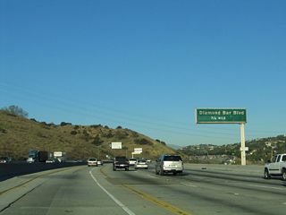 The first exit within Los Angeles County along northbound California 57 is Exit 14, Diamond Bar Boulevard, three-quarters of a mile. California 57 enters the city of Diamond Bar. A former cattle ranch (Diamond Bar Ranch), much of the city was master planned and developed through the 1960s, 1970s, and 1980s. Population increased as the Pomona Freeway opened, and Diamond Bar incorporated as a city on April 18, 1989. The population of Diamond Bar was 56,287 as of the 2000 Census.
