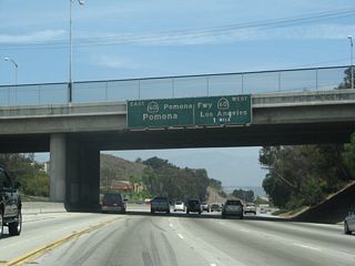 The next exit along northbound California 57 is Exit 16, California 60 (Pomona Freeway) west to Los Angeles, one mile. Northbound California 57 and eastbound California 60 merge for a couple miles after this interchange. Through traffic should remain in the left lanes; the right lanes connect to California 60 west.
