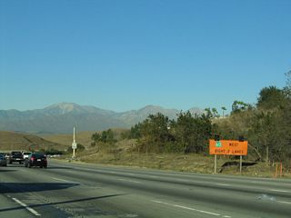 A temporary orange construction sign advises that traffic for Exit 16 (California 60 west) should use the right two lanes. With the extension of carpool lanes and new direct connectors, signage through the Diamond Bar area has changed.