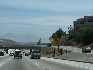 This series of pictures follows California 57 north as it merges with California 60 east. The first picture shows the link to California 60 west (Exit 16), while the second picture shows the carpool lane separation from California 57 north. In the third picture, traffic from California 60 east merges from the left with California 57 north.