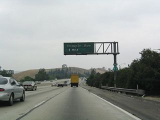 The first exit along California 57 after it splits from California 60 is Exit 20, Temple Avenue, one mile. Note that the sign bridges revert to the same model used south of California 90 (Imperial Highway).