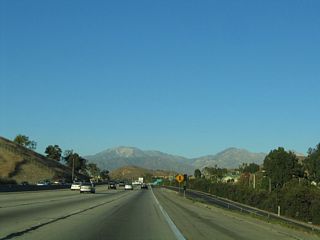 The San Gabriel Mountains loom in the distance ahead.