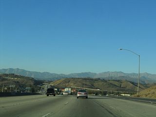 The Kellogg Interchange, built in 1972, is the point where California 57 (Orange Freeway), Interstate 10 (San Bernardino Freeway), and California 71 (Chino Valley Freeway) come together. This interchange is named for the old Kellogg Ranch, which predates the construction of the freeway interchange and the nearby residential and commercial development. After passing under Temple Avenue, California 57 curves north to pass on the top level of this symmetrical stack interchange. Direct access, high-speed ramps connect California 57 with both directions of Interstate 10, but no access is provided to California 71 south as it is considered to be an illogical connection.