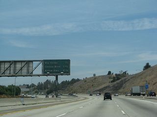 As California 71 merges onto northbound California 57 to the right, this mileage sign provides the distance to the next three exits: Exit 22, Via Verde/Raging Waters; Exit 24A, Covina Boulevard; and Exit 24B, Arrow Highway. The latest Interstate Highway Route Log and Finder List from the Federal Highway Administration (from 2002) still acknowledges the segment of California 57 between Interstate 10 and California 210 as being part of Interstate 210. Since this short segment was built with Interstate Highway funds, it is not clear if the updated route log will reassign those miles to the proposed new Interstate 210 that is currently designated as California 210.