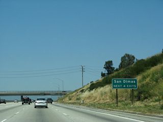 The next four exits along California 57 (Orange Freeway) north (former Interstate 210 west) serve the city of San Dimas: Exit 22, Raging Waters Drive and Via Verde; Exit 24A, Covina Boulevard; Exit 24B, Arrow Highway; and Exit 25A, Allen Avenue/Auto Centre Drive.
