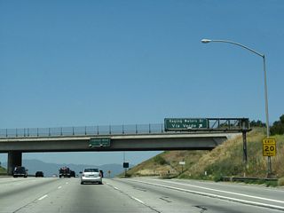 Northbound California 57 (Orange Freeway) reaches Exit 22, Raging Waters Drive and Via Verde. The next exit along northbound is Exit 24A, Covina Boulevard.
