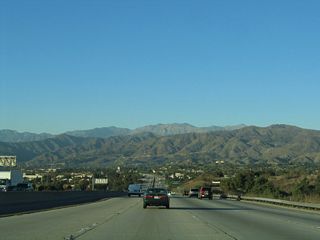 These mountains are an effective barrier to keep any further development north of San Dimas. Inversion layers keep fog and smog from reaching the top of the mountains, leaving somewhat obscured visibility on days with high pollution.