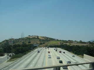 Now on the transition ramp from California 57 north to Interstate 210 west, this view looks west on the main lanes of Interstate 210.