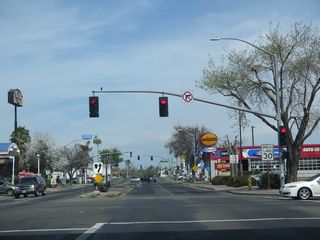 Northbound V Street passes under California 99 and approaches its signalized intersection with 14th Street, which serves as the freeway frontage road and carries both California 59 north and California 140 west. From here, California 59 proceeds ahead toward downtown Merced.