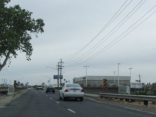 A 1940 bridge carries California 59 and California 99 Business (16th Street) over Bear Creek in Merced.