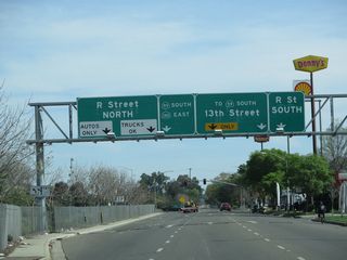 Between V Street and Martin Luther King, Jr. Way, California 59 travels along a one-way couplet along 13th Street and 14th Street. Northbound traffic actually utilizes a brief segment of the California 99 freeway itself, then takes 14th Street northwest to V Street. Southbound traffic follows 13th Street southeast all the way from V Street past R Street to Martin Luther King, Jr. Way without actually entering the freeway. This sign, posted on southbound 13th Street, confirms that California 59 remains off the California 99 freeway, while California 140 jumps onto the freeway.
