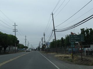 This mileage sign along California 59 south provides the distance to El Nido (11 miles), Los Banos (34 miles), and Gilroy (82 miles). The latter two destinations are via California 152 west.