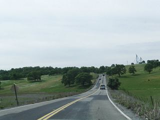 Tuolumne County J-59 (La Grange Road) passes through the foothills of the Sierra Nevada. The hills were green from recent rains from the winter season.