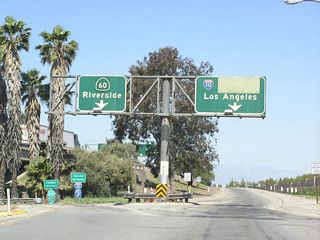 This old sign, which dates back to when California 60 was signed as U.S. 60 and Interstate 10 was also signed as U.S. 70-99, has been covered with green overlays to hide the old U.S. route designations and advise of the simpler California 60 and Interstate 10 designations.