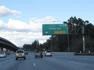 Traffic from California 57 (Orange Freeway) merges onto California 60 (Pomona Freeway) east from the right. The two routes briefly share alignment, with one mutual interchange at Exit 24B, Grand Avenue.