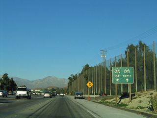 A roadside sign (posted after the Grand Avenue off-ramp) advises that California 60 east and California 57 north will split at Exit 25. California 57 proceeds north to San Dimas and Interstate 210, while California 60 leads east into Pomona and Ontario.