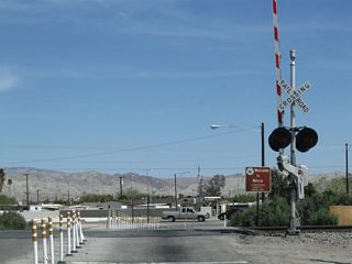U.S. 60-70 crossed the railroad northeast from Grapefruit Boulevard (SR 111) via 4th Street into the unincorporated community of Mecca. Upon crossing the railroad tracks, U.S. 60-70 turned south onto Hammond Road. The intersection of 4th Street and Hammond Road was reconfigured into a roundabout by 2019.