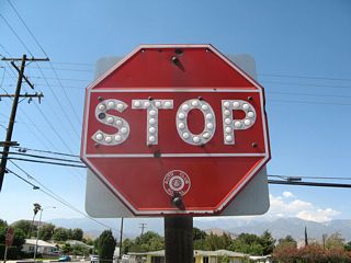 This old, porcelain-enamel, button-copy stop sign dates to the era when the Automobile Club of Southern California (ACSC) used to maintain and install signs, including route markers and traffic control. Rarely found still in use today, this stop sign remained in use at the Banning Post Office parking lot, two blocks north of Ramsey Street (old U.S. 60-70-99) until 2017.