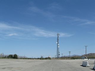 A short segment of old U.S. 60/70 remains in use along the north side of Interstate 10. Chiriaco Road extends east by a gas station and radio tower.