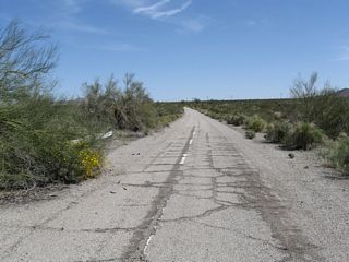The newer alignment of U.S. 60/90 along Pinto Road continues east from the first wash to overtake the original route along Box Canyon Road.