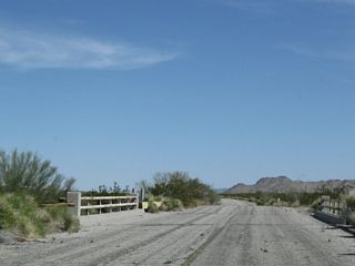 Another bridge from the same era takes Pinto Road across the second wash east of Cottonwood Springs Road. The railing for this bridge is more common to the World War II era when surplus supplies were shipped out for the war effort. Hence, old railroad tracks were used for the bridge railing rather than concrete bridge rails found on other comparable bridges.