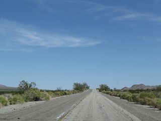 Remaining yellow and older white lane striping along Pinto Road east of the second wash bridge.