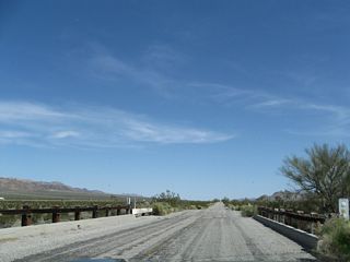 Pinto Road crossing the third wash east of Cottonwood Springs Road.