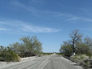 Pinto Road east at the fourth wash in Shavers Valley. Construction of this alignment in the early 1940s included bridges, unlike the older segments through Shavers Valley and Maniobra Valley that have been damaged by seasonal floodwaters.