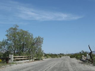 The final bridge crosses washes from the adjacent dike system to the south is the eighth bridge along Pinto Road between Cottonwood Springs Road and Chiriaco Summit.
