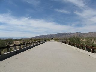 White, wooden railing lined the bridge taking Pinto Road over the 9th wash west from Chiriaco Summit.