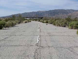 The interchange joining Interstate 10 with Cottonwood Springs Road comes into view along Pinto Road west. Pinto Road bedns southward into Cottonwood Springs Road.