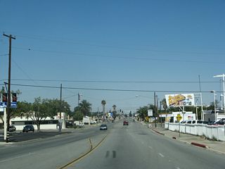 Eastbound Sixth Street (old U.S. 60-70-99) advances to Palm Avenue, a wide boulevard that features a landscaped median at it travels north through Beaumont.