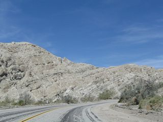 Sandstone rock formations line both sides of the canyon, which is subject to flooding during rainstorms during Winter and Summer monsoons. Palo verde and sage scrub grows near the canyon floor, but life is otherwise limited in Box Canyon.