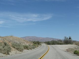Beyond the distant Cottonwood Mountains lies Pinto Basin, which is home to Joshua Tree National Park and its unique Joshua Trees found in the Mojave Desert.