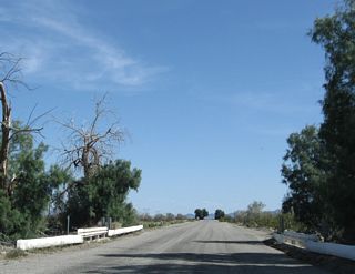 The fourth wash bridge on Chuckwalla Road features white painted metal guardrail rather than wooden bridge railing.