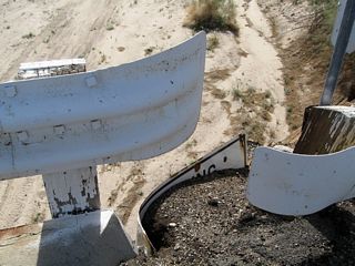 For some bridges along former U.S. 60-70 in the Chuckwalla Valley, old porcelain enamel signs help support the bridge abutments. These recycled signs are impossible to remove as they are firmly embedded into the bridge.
