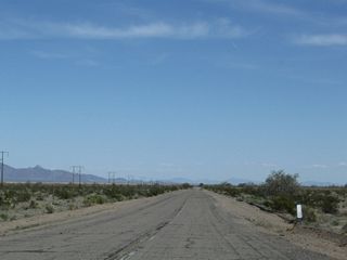 Historic U.S. 60-70 continues to pass through the flat valley with occasional dips and rises for washes. Note that some dips could be flooded during rain events.
